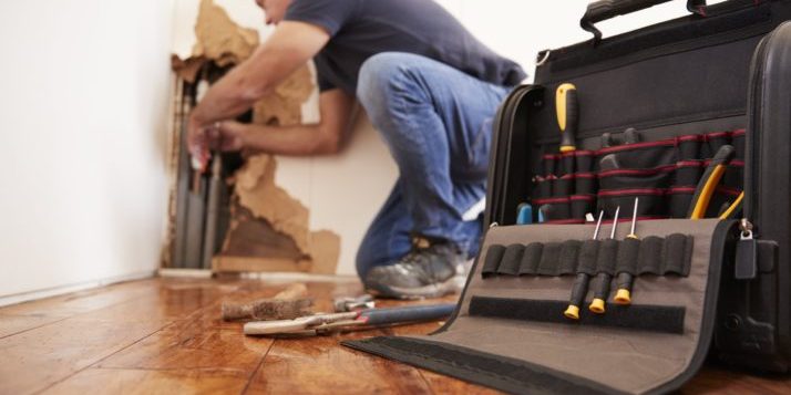 Man fixing plumbing with tools.